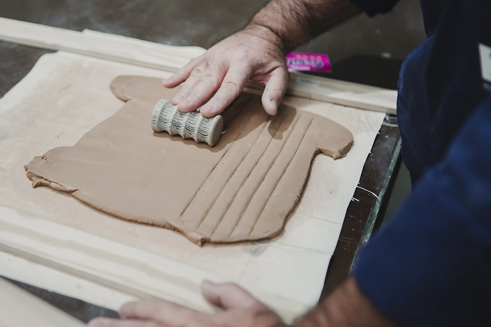 Artesano Macer diseñando relieves cerámicos artesanales